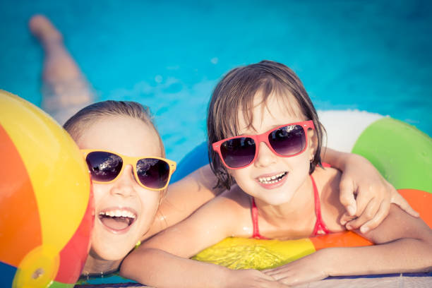 istock Happy children in the swimming pool 979499196