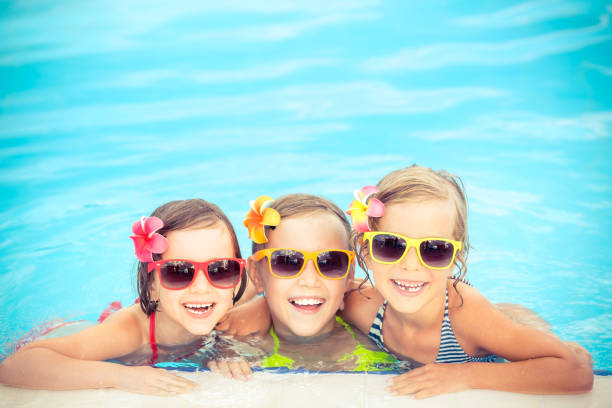 istock Happy children in the swimming pool 979499226