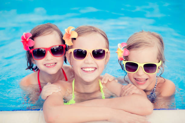 istock Happy children in the swimming pool 979499252