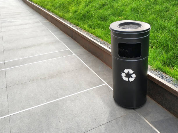 istock Recycling can with grass field and outdoor tiled floor 979507854