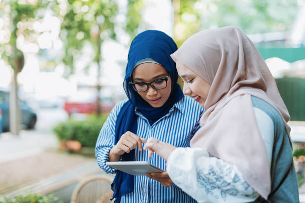 istock Two Malaysian Muslim women using digital tablet for business 979508392