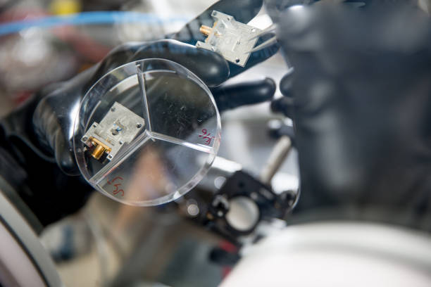 Researcher Preparing Samples in Glove Box for Measuring Transient Photocurrent in Organic Semiconductors Researcher Preparing Samples in Glove Box for Measuring Transient Photocurrent in Organic Semiconductors. glove box stock pictures, royalty-free photos & images