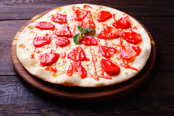 istock seasonal fruit strawberry pizza at dark background 979523524