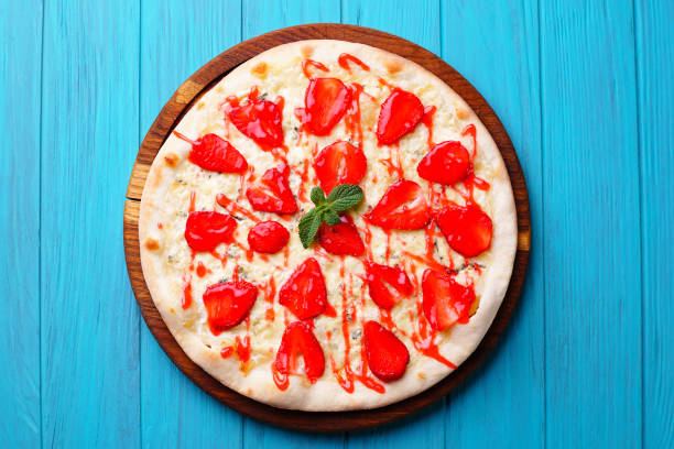 istock seasonal fruit strawberry pizza at blue background 979525422