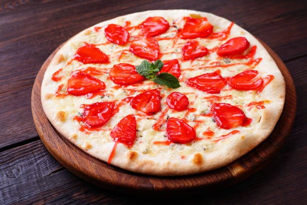 seasonal fruit strawberry pizza at dark background