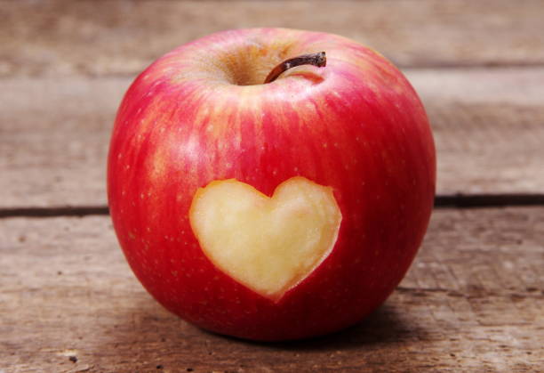 istock Close-Up Of Apple On Heart 979546106