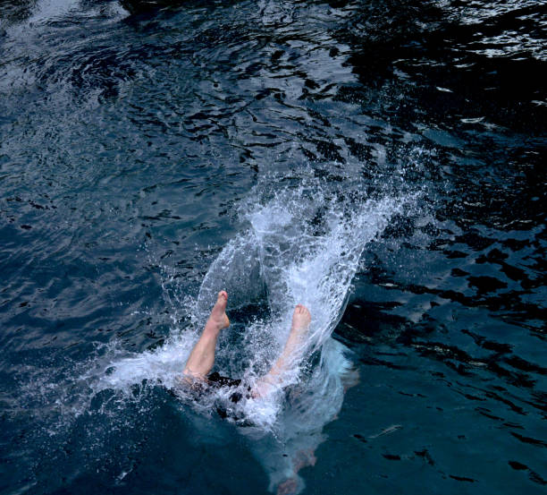 istock legs of a man into the water after jumping 979555564