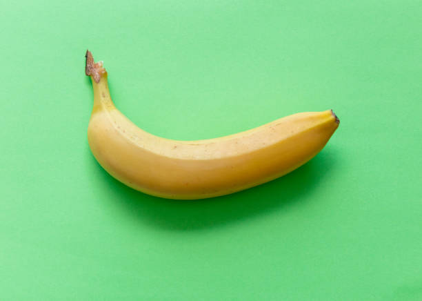 istock Yellow banana isolated on green background. 979558442