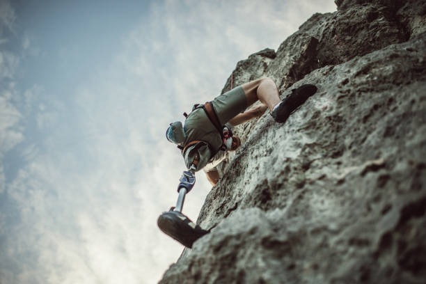 istock Disability man climbing high 979562316