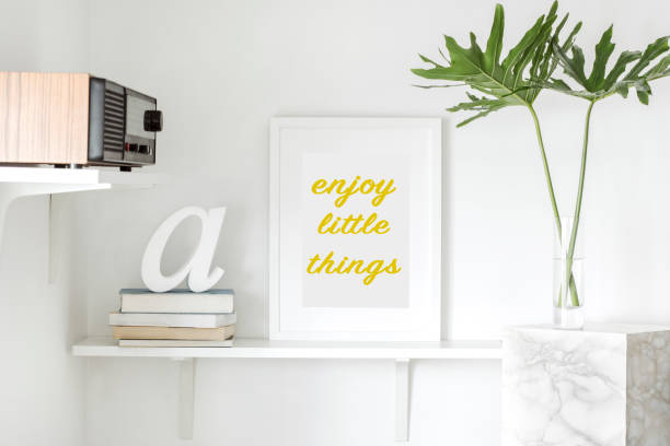 istock The modern interior with shelfs, radio, books, leafs and mock up frame. 979566210