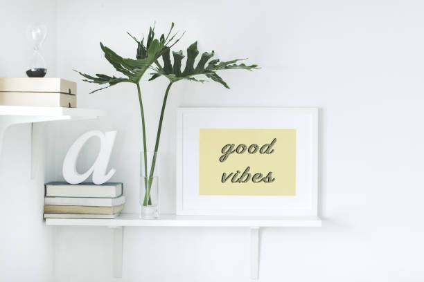 istock The modern interior with shelfs, books, leafs and mock up frame. 979566354