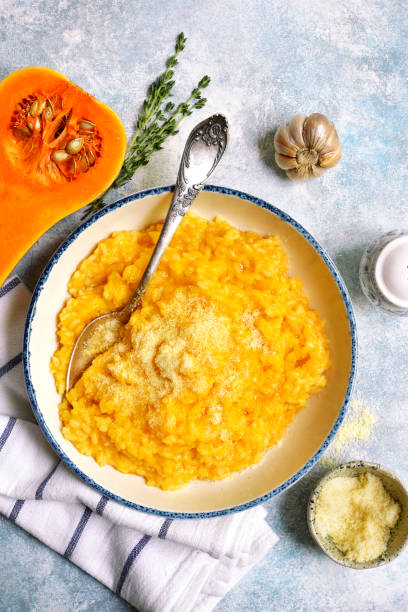 Delicious pumpkin risotto with garlic and thyme stock photo