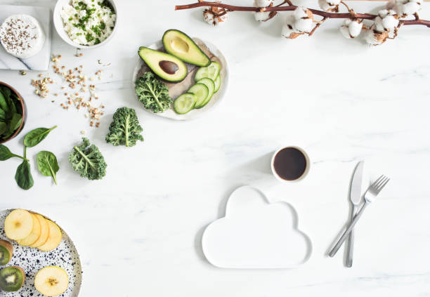 The top viev of super food on the white marble table. Flat lay. Variuos vegetables ingredients and healthy food for vegetarians.