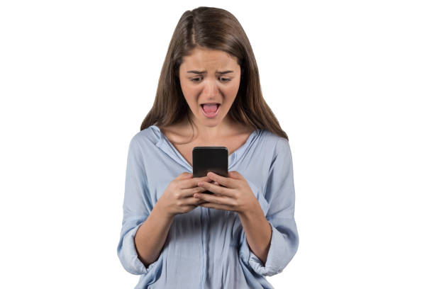 istock Young woman looking worryingly at her cell phone 979579372