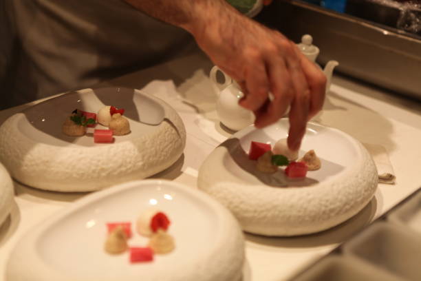 istock Michelin Starred Chef is plating a  dessert in a white stylish bowl. 979579436