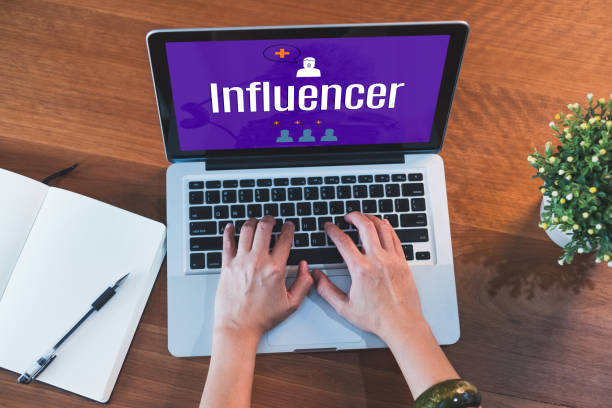 istock Top view hand type on laptop keyboard with influencer on laptop screen and plant on table at home.digital technology business.blogger tool for engage viewer 979586182