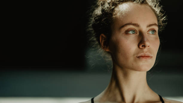 istock Female young beautiful dancer practicing with concentration on the dark background in natural scenery. 979588502