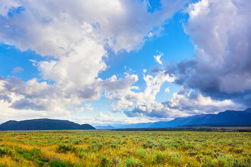 Big bold cloudy sky over the open spaces just outside of Jackson Hole, Wyoming