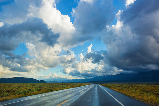 Big bold cloudy sky over a wide open road just outside of Jackson Hole, Wyoming