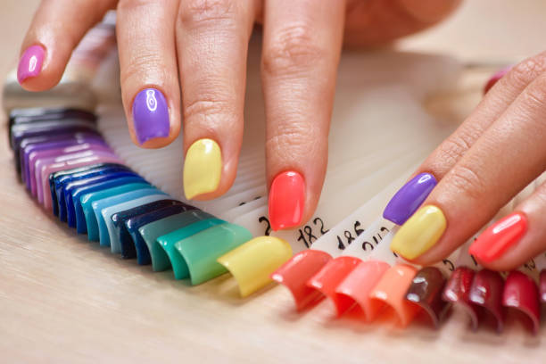 istock Summer colored manicure on female fingers. 979619826