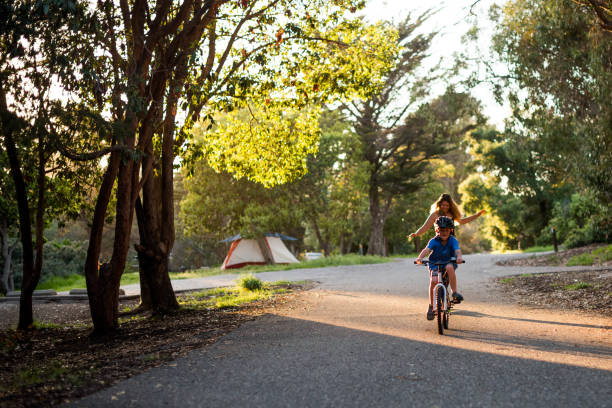 istock Mom and son racing while biking and skate boarding 979620154