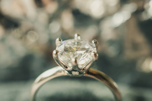 istock luxury engagement Diamond ring with abstract bokeh light background 979620290