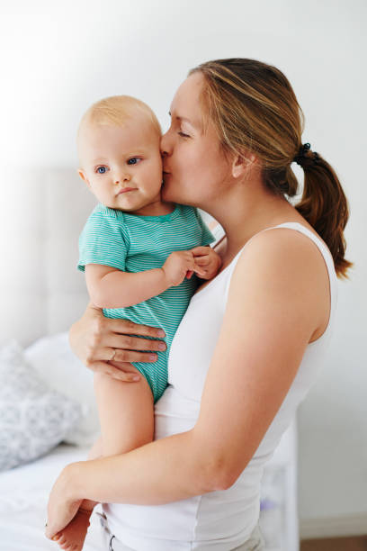 istock Mom just keeps those kisses coming 979629328