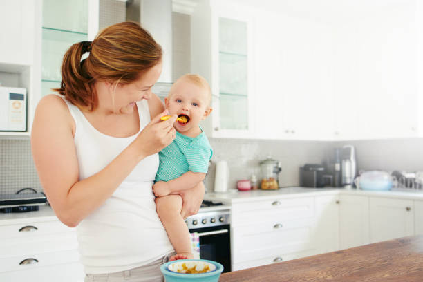 Mother with baby on your lap drinking tea at home