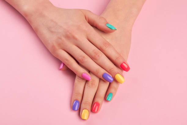 istock Female hands with colorful polish nails. 979630224