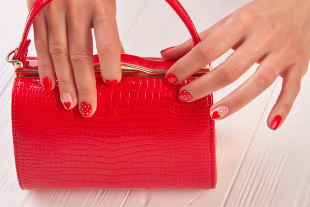 istock Red manicure and red clutch. 979630706
