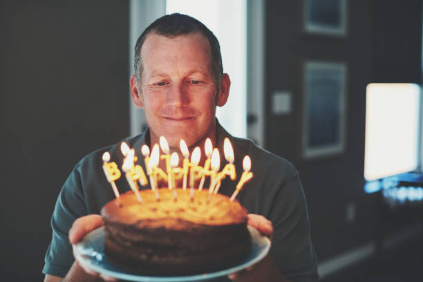 istock Mature man with birthday cake 979637642