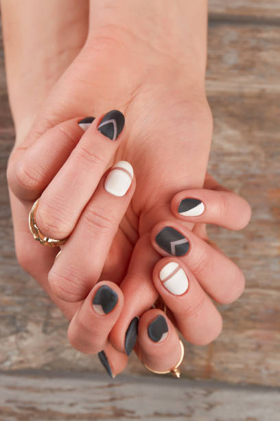 istock Black and white matte manicure close up. 979638088