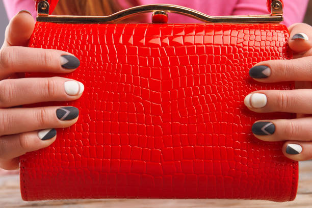 istock Manicured hands holding luxury handbag. 979638124