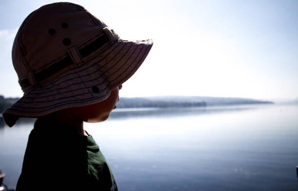 istock Boy by the lake in silhouette 979644650