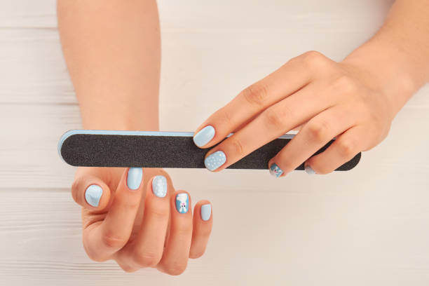 istock Woman hands filing nails to herself. 979644752