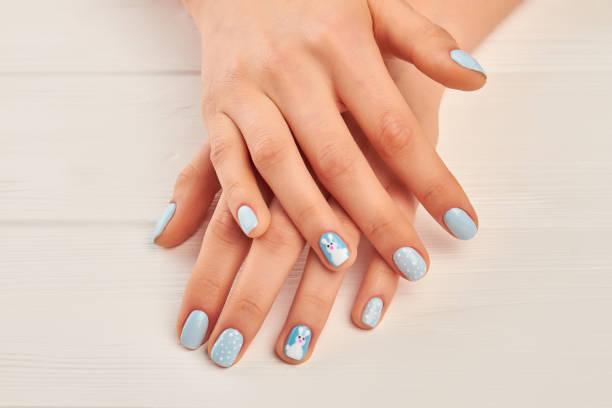 istock Female hands with winter manicure. 979644836