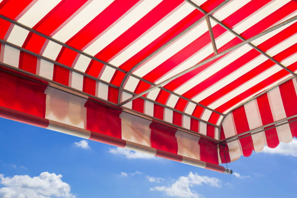 istock red and white striped awning isolate on white background, shading canvas with steel structure background 979647866