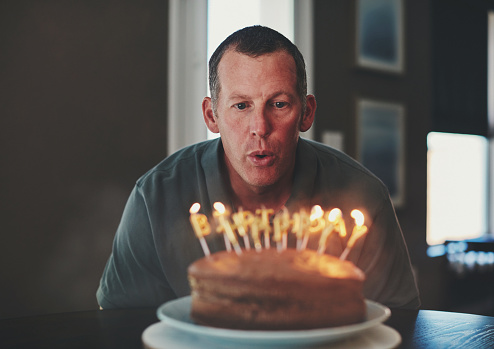 Mature man with birthday cake