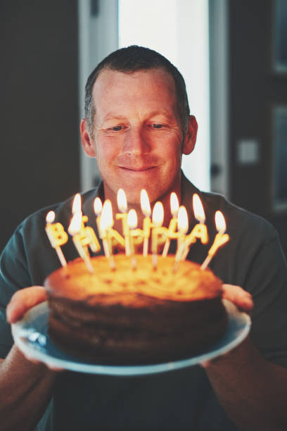 istock Happy mature man with birthday cake 979654012