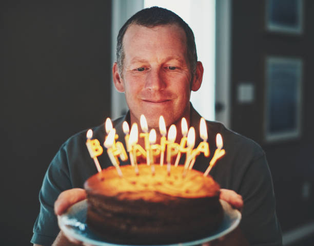 istock Happy mature man with birthday cake 979654026