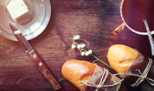 istock Fresh rolls for breakfast. Bun with butter to a cup of coffee in 979654674
