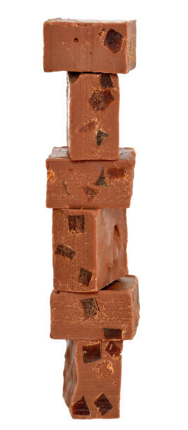 istock Chocolate cubes tower filled with orange candied fruit isolated 979665260