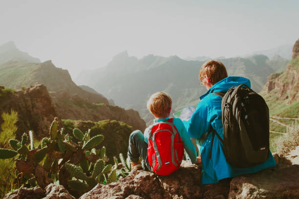 istock father and son travel in mountains 979667420