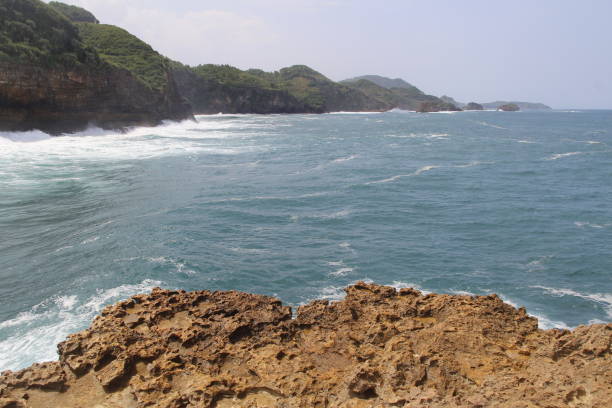 istock Natural cliff formation with the wave at Timang Beach 979670790