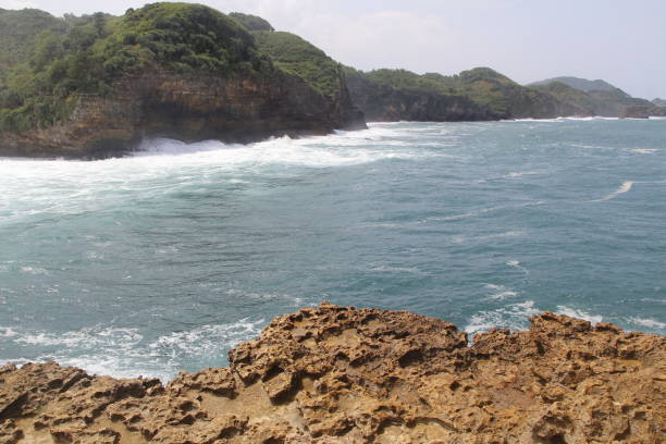 istock Natural cliff formation with the wave at Timang Beach 979670818