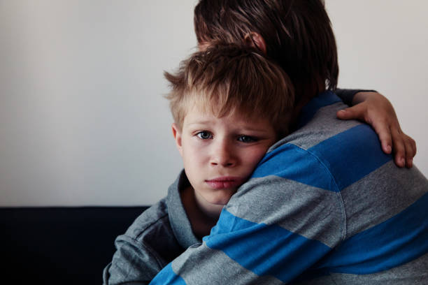 istock Father comforting sad child, parenting, sorrow 979672292
