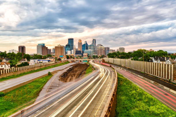 istock Minneapolis Skyline at Sunset with Traffic Light Trails 979679486