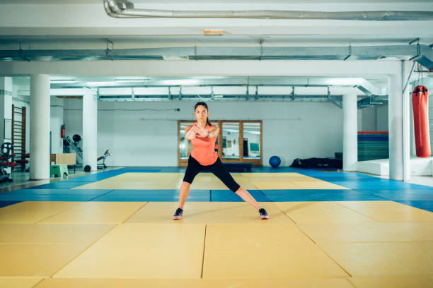 istock Young fitness instructor showing exercises for people with osteoporosis problem 979684064