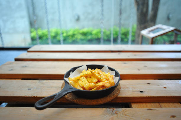 French fries on wooden table.