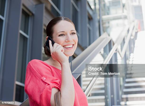 Woman Talking On Cell Phone On Sunny Stairs Stock Photo - Download Image Now - 20-24 Years, Adult, Adults Only